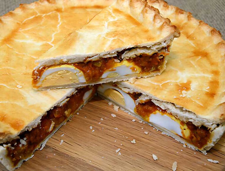 Curried egg pie. Hard-boiled eggs with a curry sauce inside a pie crust - from a recipe by Marguerite Patten (November 1915 to June 2015)