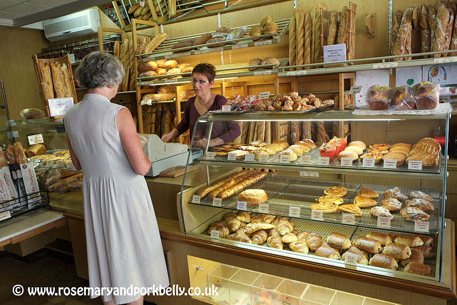 Freshly baked golden baguettes displayed at a traditional French boulangerie in Gennes, Anjou, France