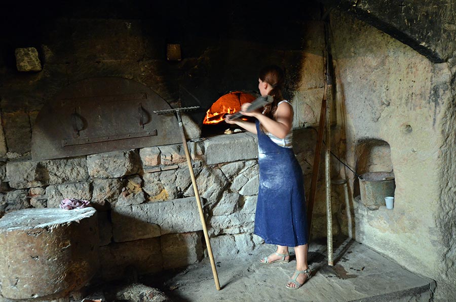 Cooking Fouaces in a wood fired oven at Château de Brézé, Loire France