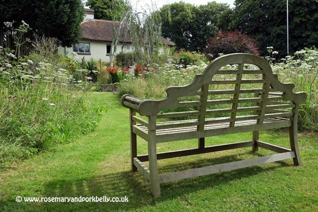 Wooden bench in the wildflower meadow, Five Oaks Cottage West Burton near Pulborough