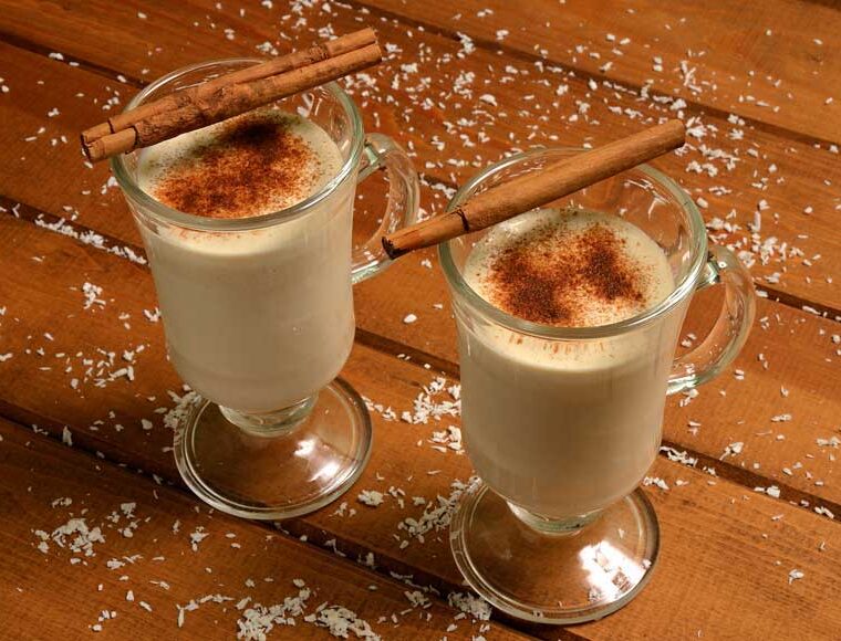 2 glasses of dairy free coconut milk eggnog served with cinnamon