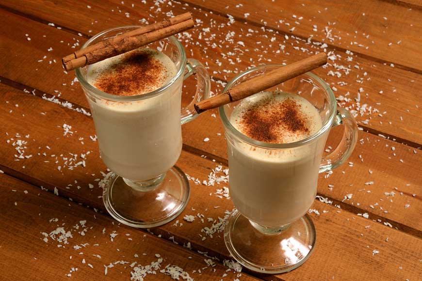 2 glasses of dairy free coconut milk eggnog served with cinnamon