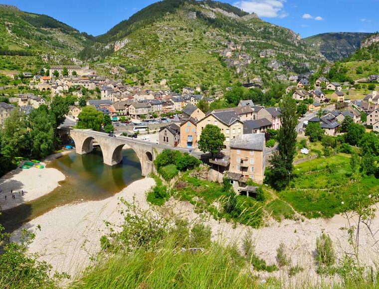 The village of Sainte-Enimie in Lozère, France at the entrance of the Gorges du Tarn, seen from a picnic area on D986 road.