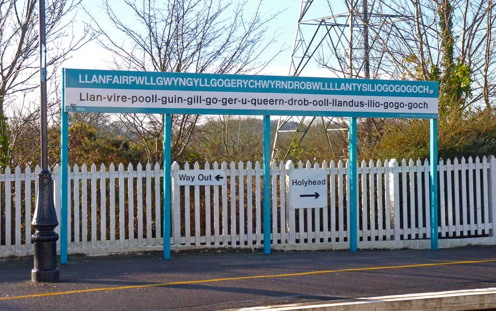 Llanfairpwllgwyngyllgogerychwyrndrobwllllantysiliogogogoch railway station sign, Anglesey, Wales. This station sign shows the name in Welsh; and underneath; how it is pronounced.