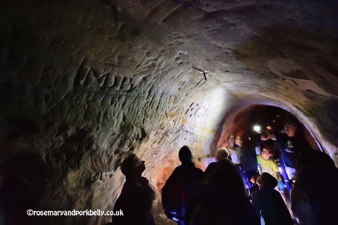 Looking at Victorian graffiti in Baron's cave, Reigate Caves © rosemaryandporkbelly.co.uk