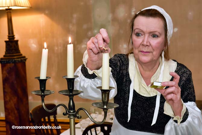 Maid in Regency costume lighting candles, Regency Town House Hove Sussex © rosemaryandporkbelly.co.uk