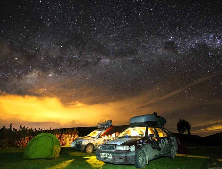 2 cars, tent and a starlit sky at dawn, Global Convoy wild camping in Peru