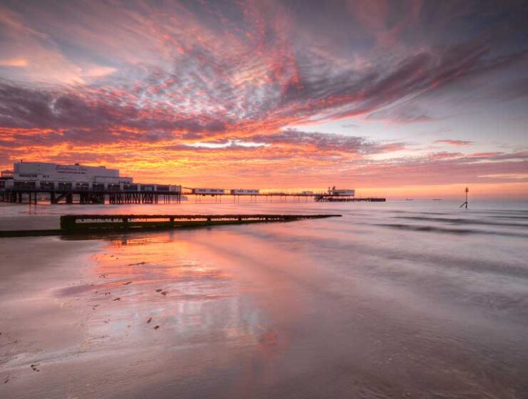 Sandown Pier at sunrise viewed from the beach © Visit Isle of Wight