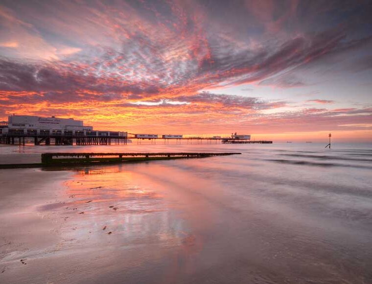 Sandown Pier at sunrise viewed from the beach © Visit Isle of Wight