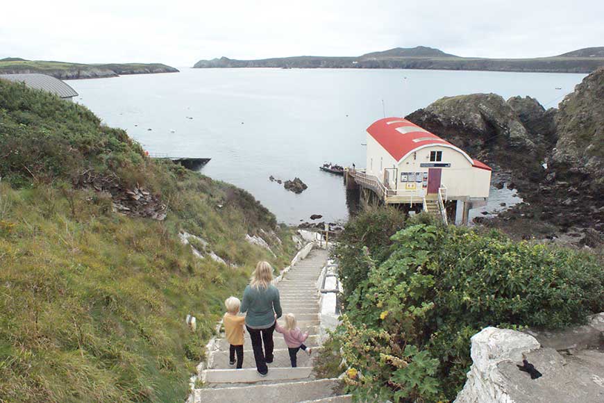 The historic St Justinian's Lifeboat Station, located near St Davids in Pembrokeshire, Wales. The building is perched on stilts overlooking a rocky bay and Ramsey Island
