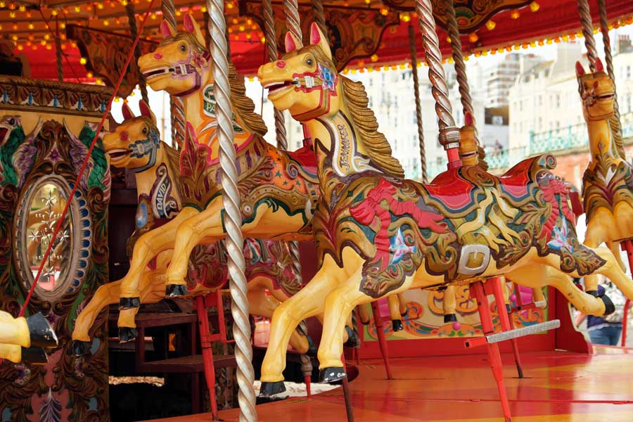 Brightly painted wooden horses on the merry-go-round on Brighton sea front, East Sussex UK 48 hours in Brighton