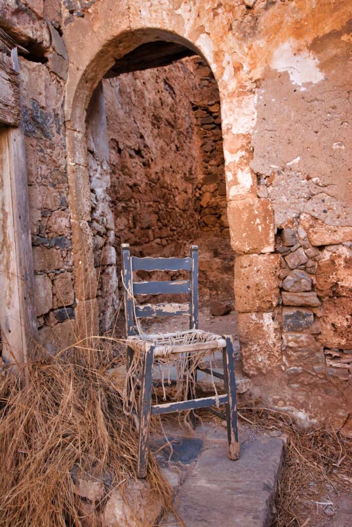 Chair and derelict building Spinalonga, Crete ©rosemaryandporkbelly