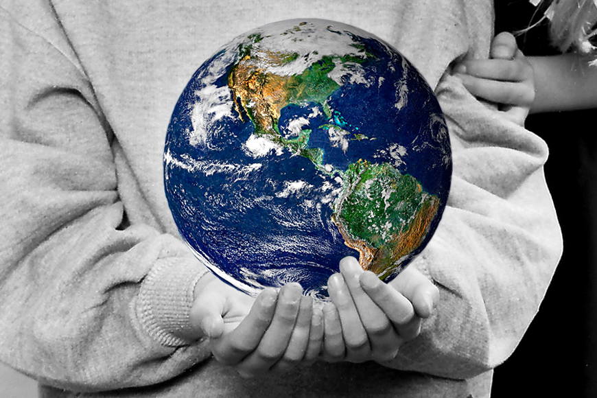 2 children holding the world