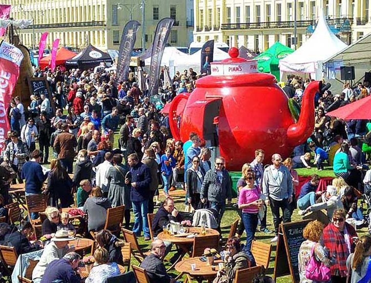Crowd of people and the red Pimm's teapot at Foodies Festival Hove Lawns East Sussex