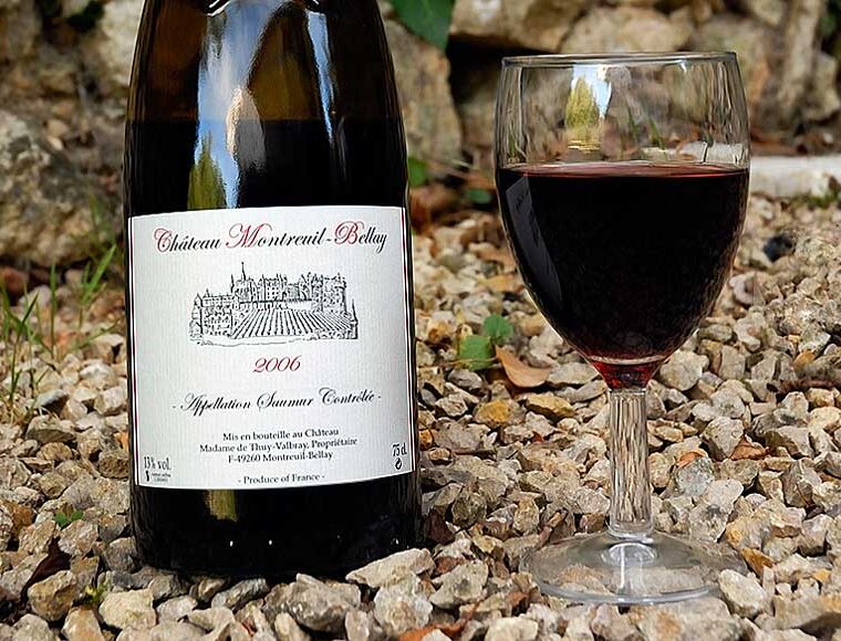A bottle and glass of Château Montreuil-Bellay wine