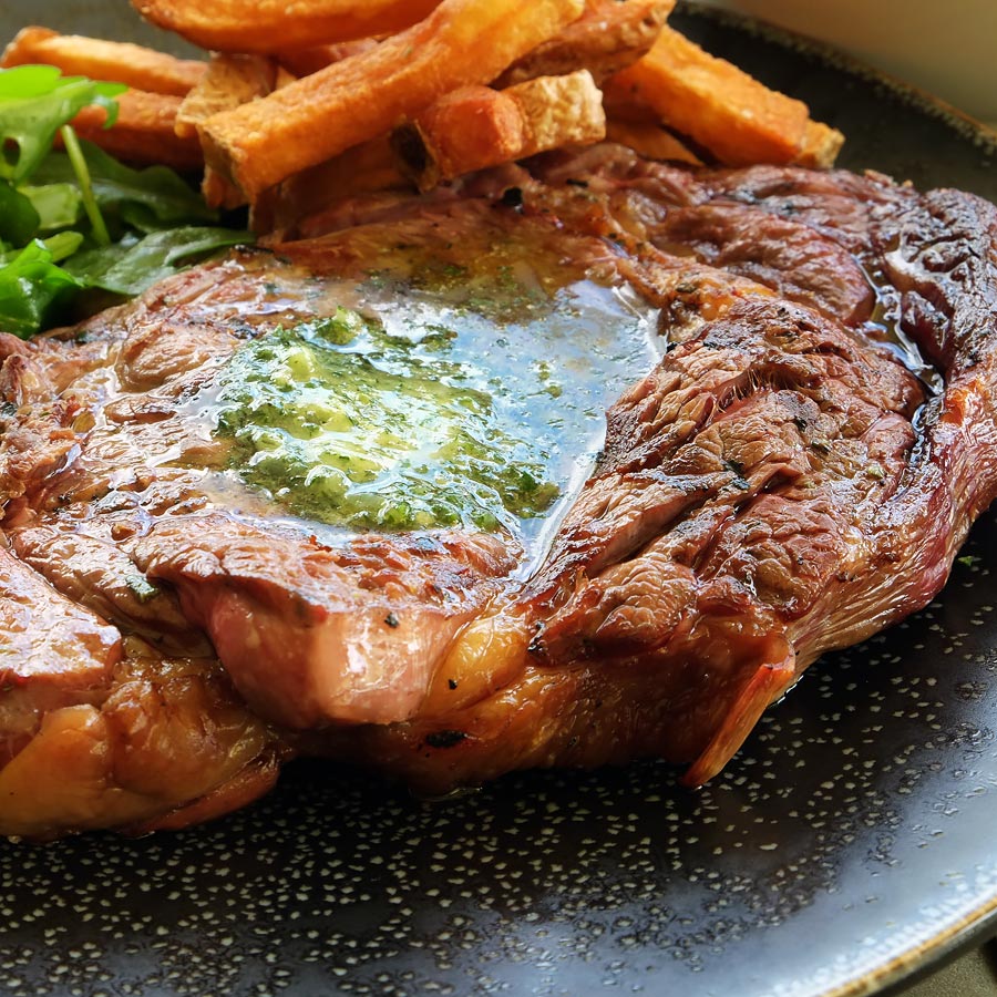 Close up photo of steak and chips