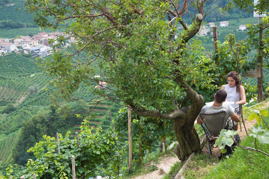 Couple sitting overlooking the Prosecco vineyards at Osteria Senz'Oste, Veneto Italy