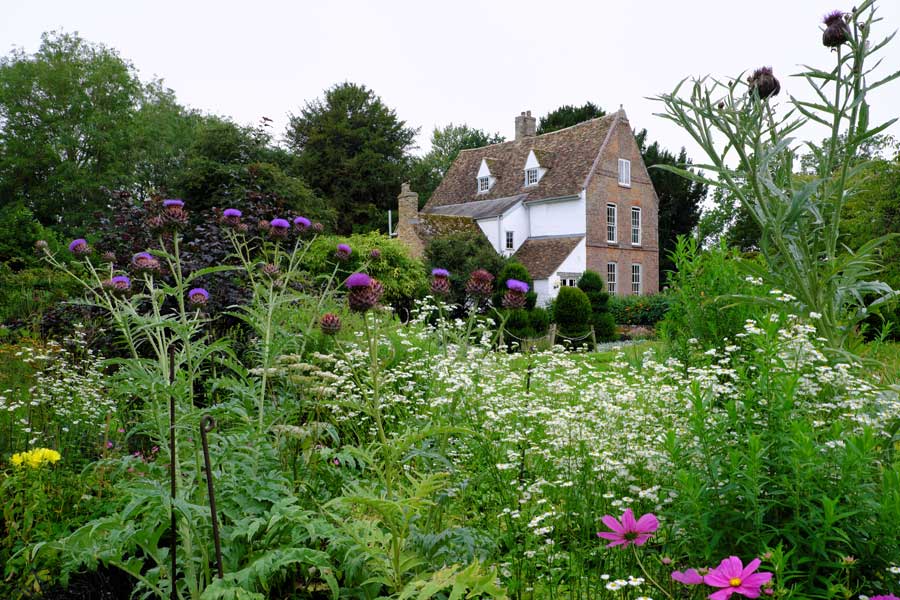 Looking across the flowerbeds to The Manor at Hemingford Grey