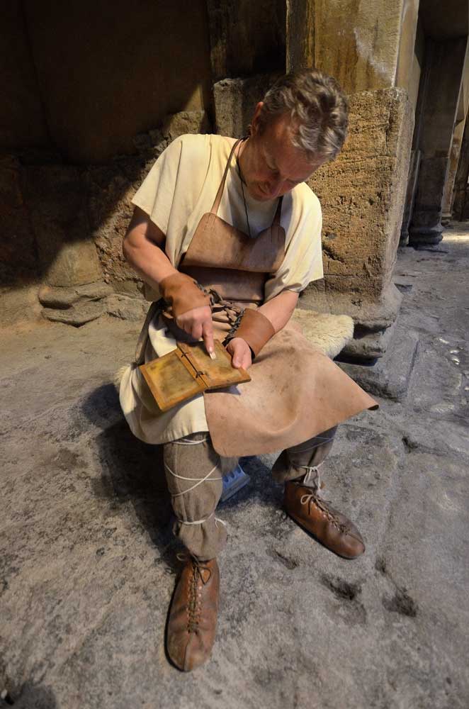 Actor playing a Roman stone mason Roman Baths, Bath Somerset