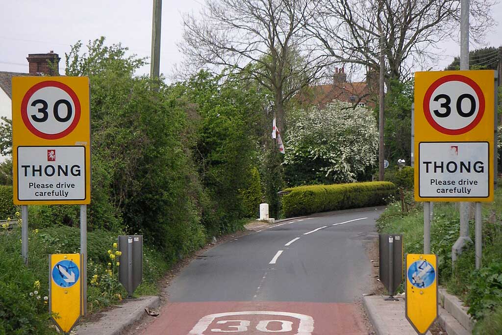 Road signs showing 30 mph speed limit at entrance to Thong a hamlet southeast of Gravesend in Kent, England.