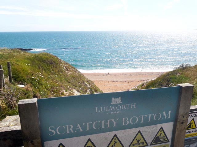 Scratchy Bottom Beach and sign in Dorset UK