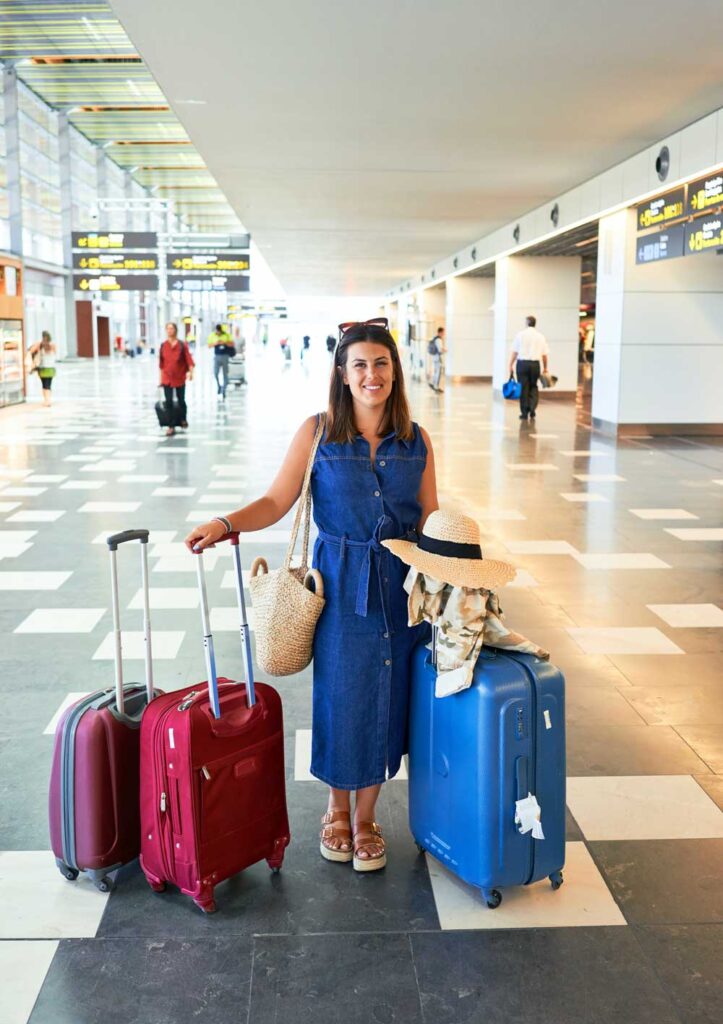 Female with luggage at airport ©krakenimages unsplash