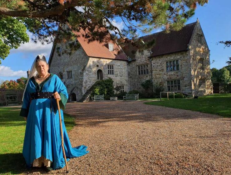 Medieval lady standing outside Michelham Priory East Sussex