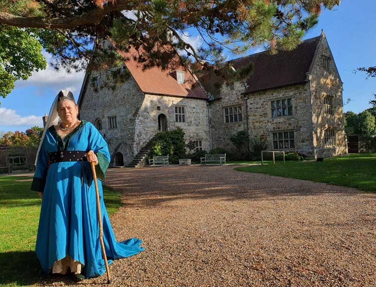 Medieval lady standing outside Michelham Priory East Sussex
