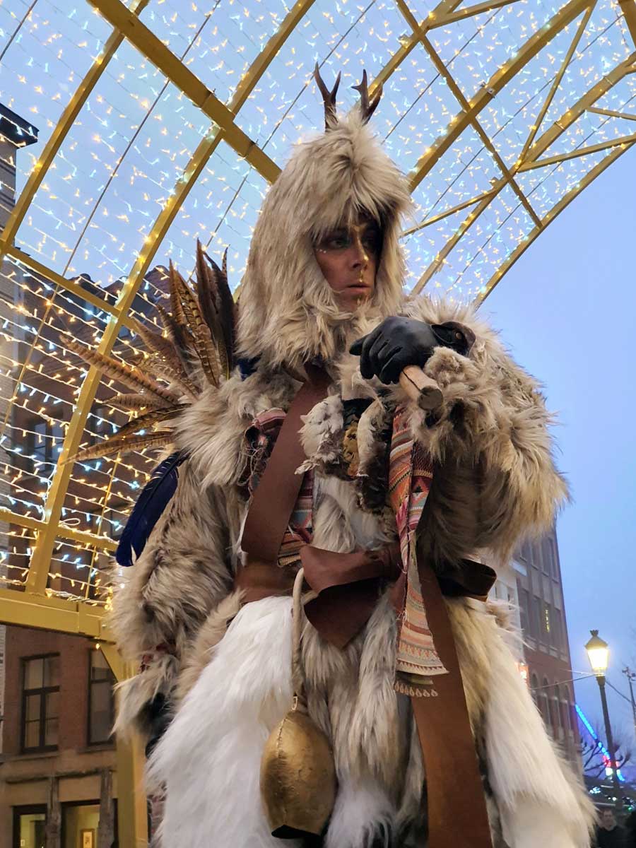 Spirit of Winter stilt walker at Antwerp Christmas market in Belgium