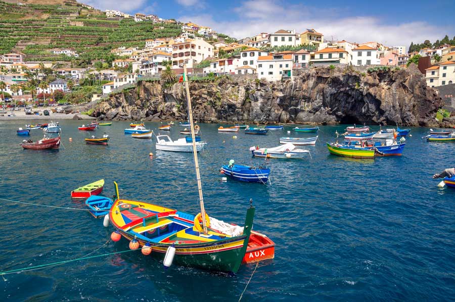 Brightly coloured boats at Câmara de Lobos viewed from the sea, Madeira