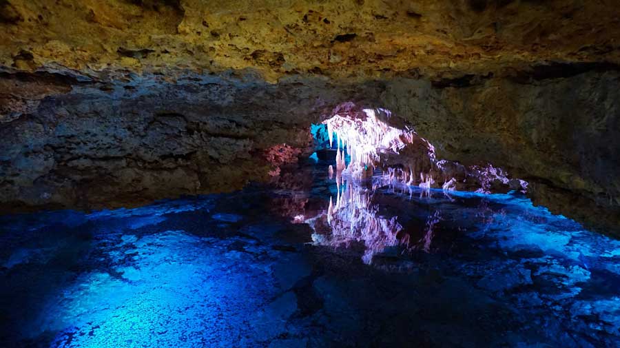 Stalactites reflect in the water of the underground lake known as the Sea of Venice, Cuevas del Hams Majorca