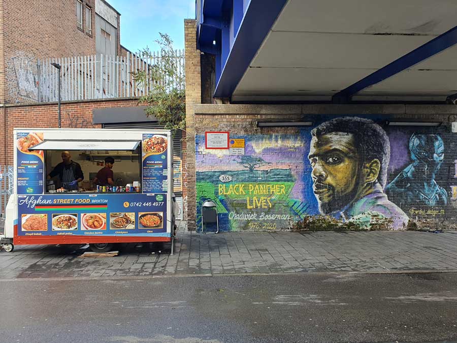 Afghan street food van and Mural of Chadwick Boseman Brixton London