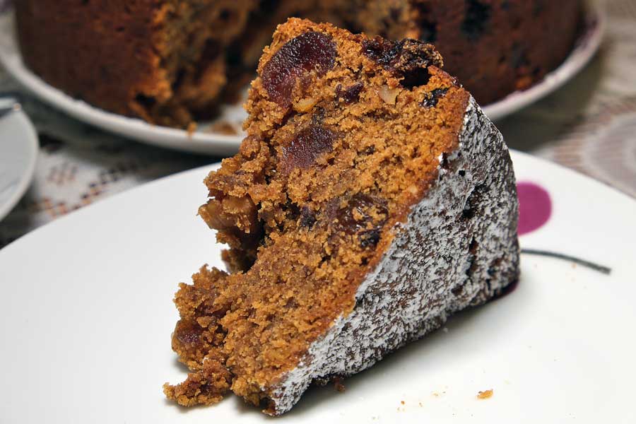 Slice of vegan cherry and walnut mincemeat fruitcake