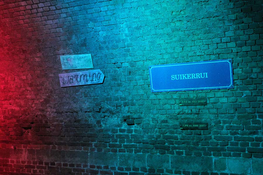 Street sign and water level markers in the historic former canals and sewers under Antwerp Belgium