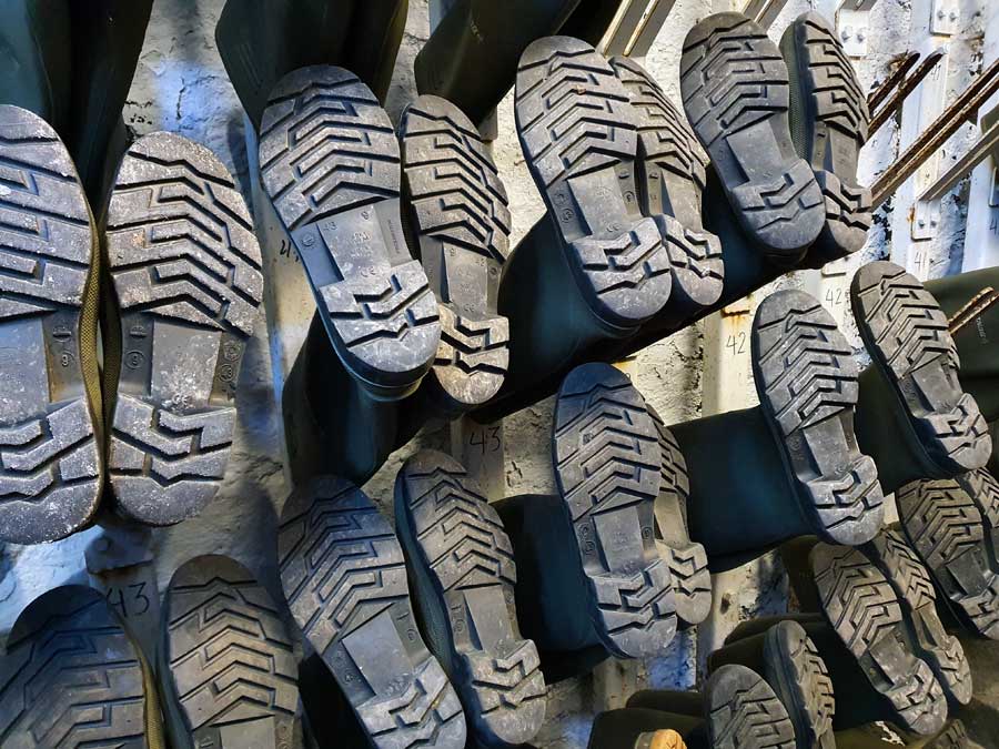 Rows of Wellington boots of different sizes at De Ruien Antwerp