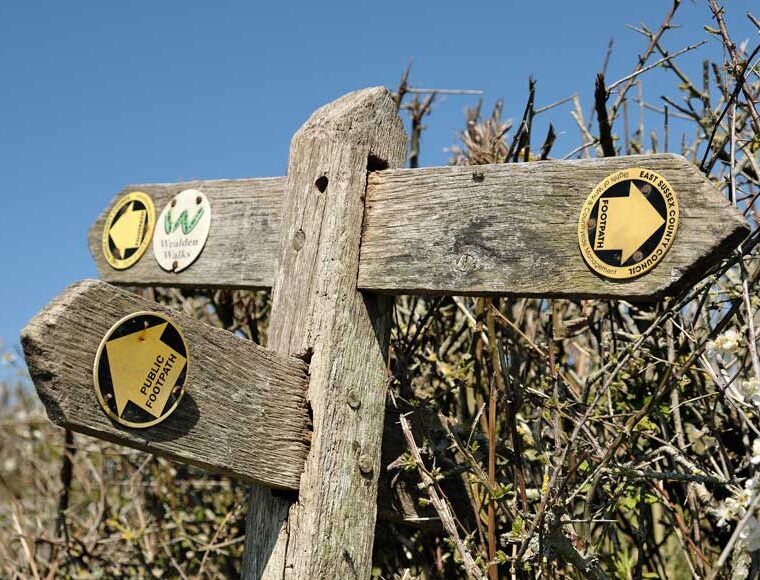 Wooden footpath signpost on the Cuckoo Trail in East Sussex
