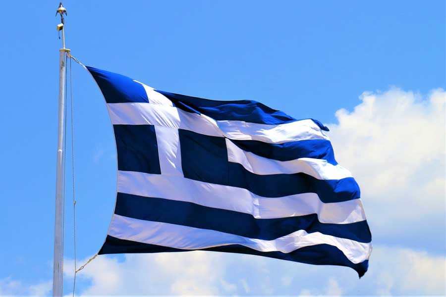 Flag of Greece against blue sky and white clouds
Image by Reissaamme from Pixabay