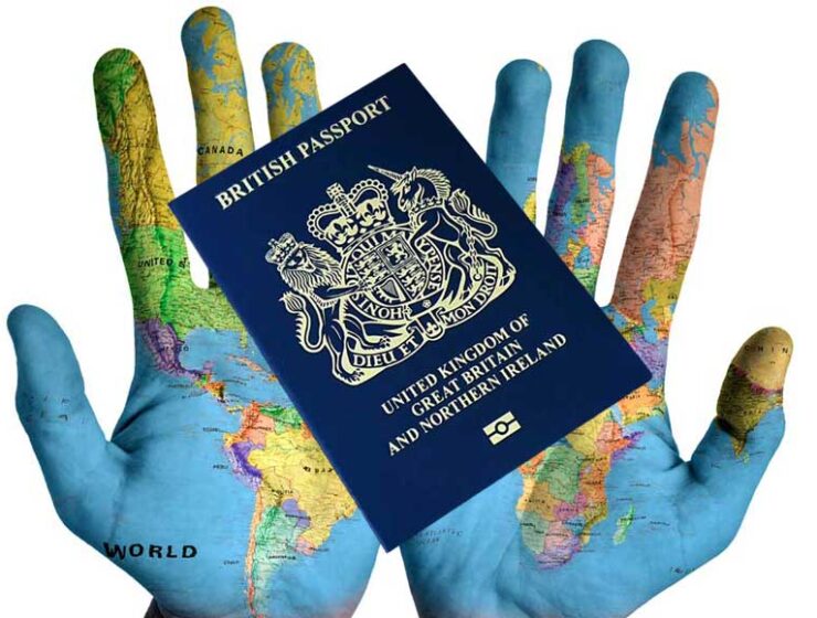 Map of the world painted on hands and UK passport