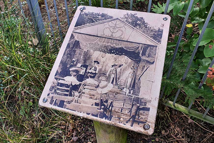 Plaque showing an old black and white photograph of a show in St Ann’s Well Gardens