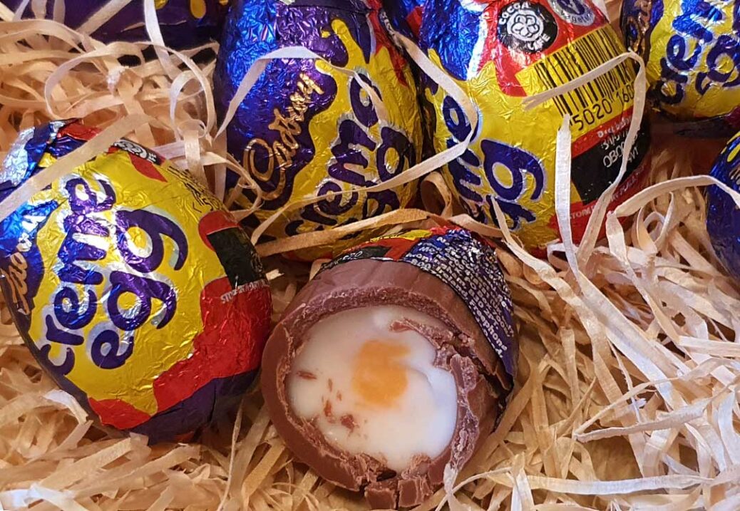 Cadbury creme eggs with one cut open to show fondant filling