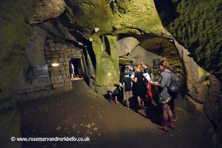 Family looking at map while underground at Château de Brézé Loire France