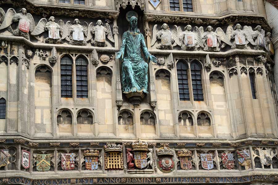 Close up of the Welcoming Christ statue, carvings and intricate stonework on Christ Church Gate Canterbury Kent