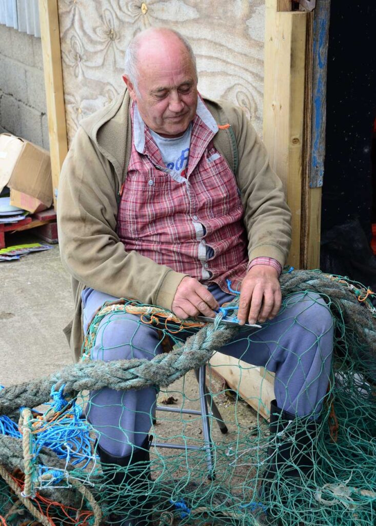 Fisherman using a homemade metal Sowester Net Needle to mend nets at Whitstable Harbour, Kent.
Things to do in Kent for free
