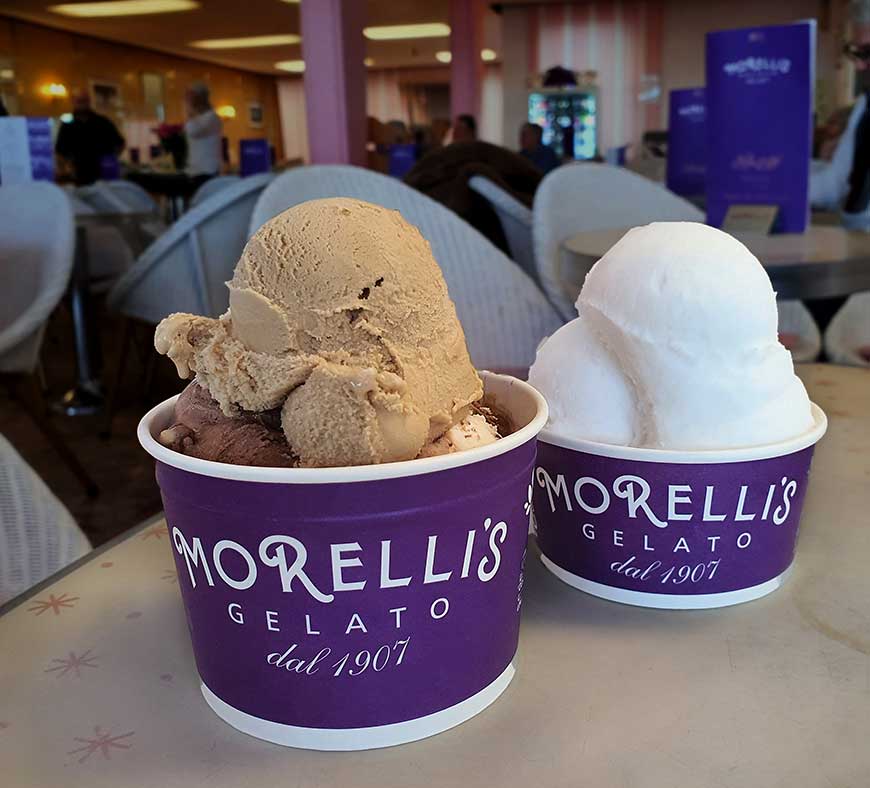 One small tub of Chocolate and one small tub of vanilla gelato ice cream on a table in Morelli's in Broadstairs Kent