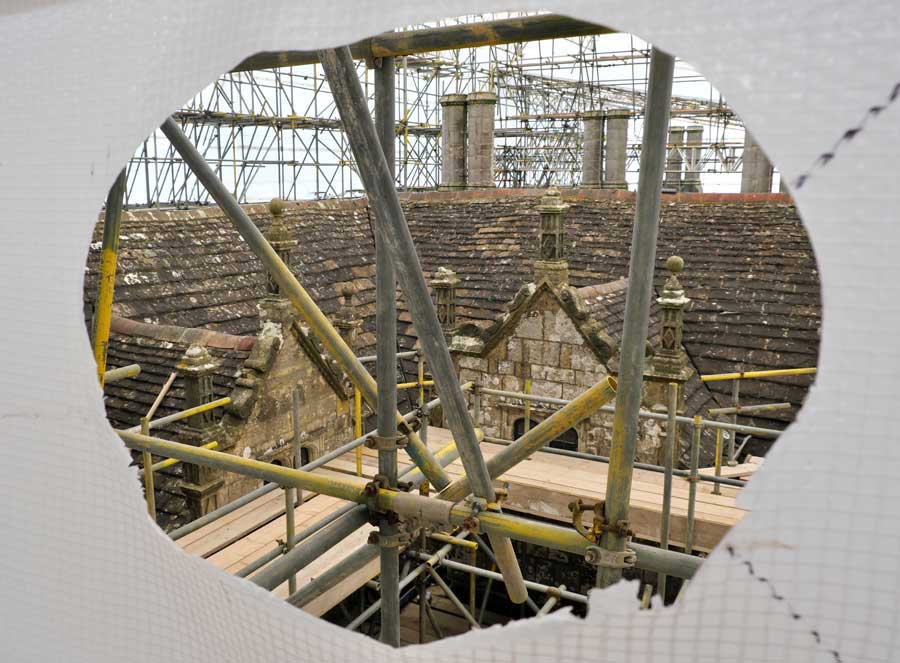 View of scaffolding and rooftop of the mansion house at Wakehurst undergoing restoration work