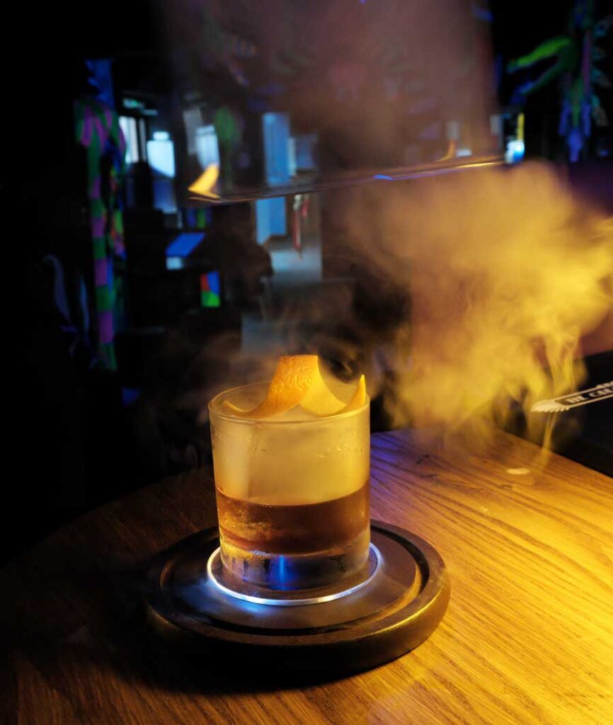 Smokey Rum and Maple Old Fashioned, made with burning cherry wood and maple syrup. Globalls Cocktail Bar Brighton Marina East Sussex UK