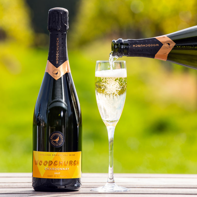 Bottle of Woodchurch sparkling Chardonnay wine and glass