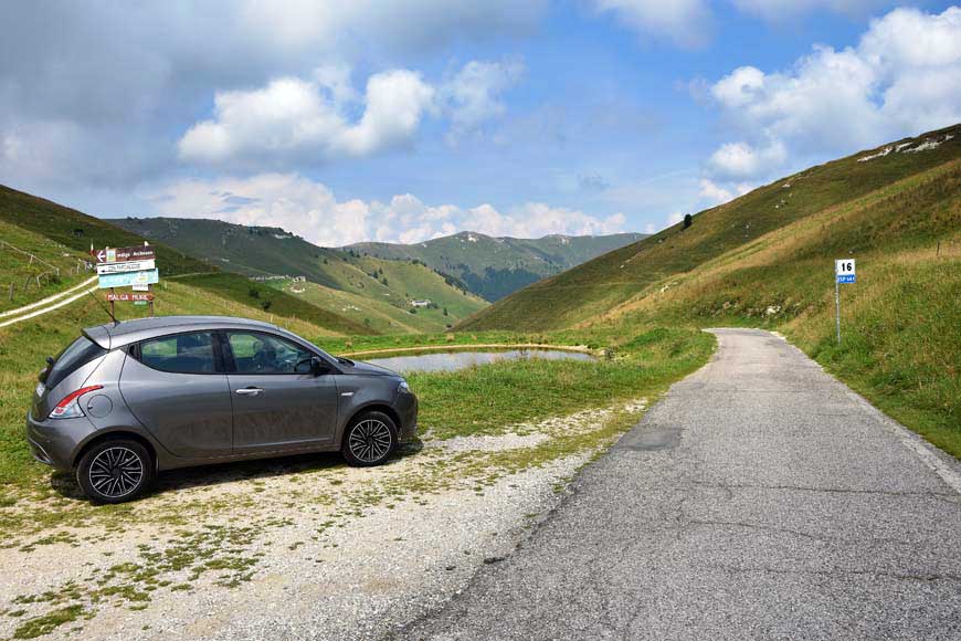 Silver grey rental car parked on the road to Malga Mure in the Italian Dolomites

Holiday rip-offs