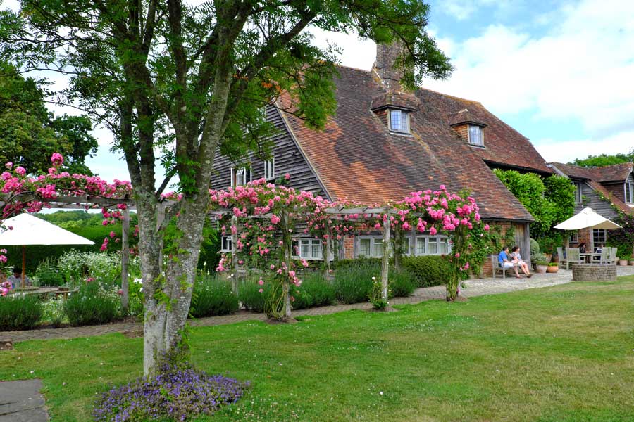 Rose pergola and 17th century Town Place Garden farmhouse West Sussex