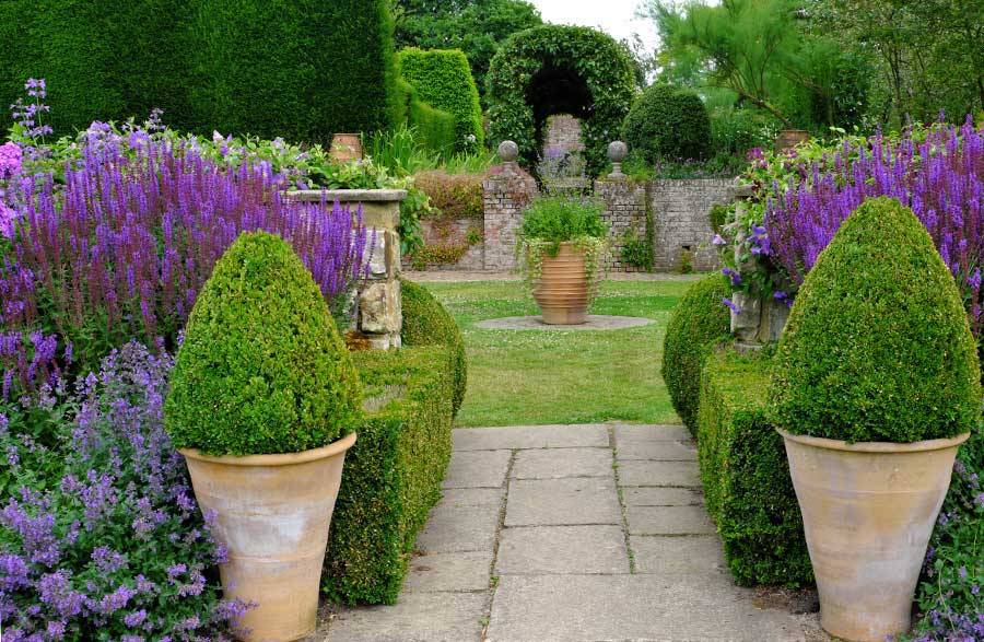 View of East Lawn through the Short Border at Town Place Garden West Sussex UK
